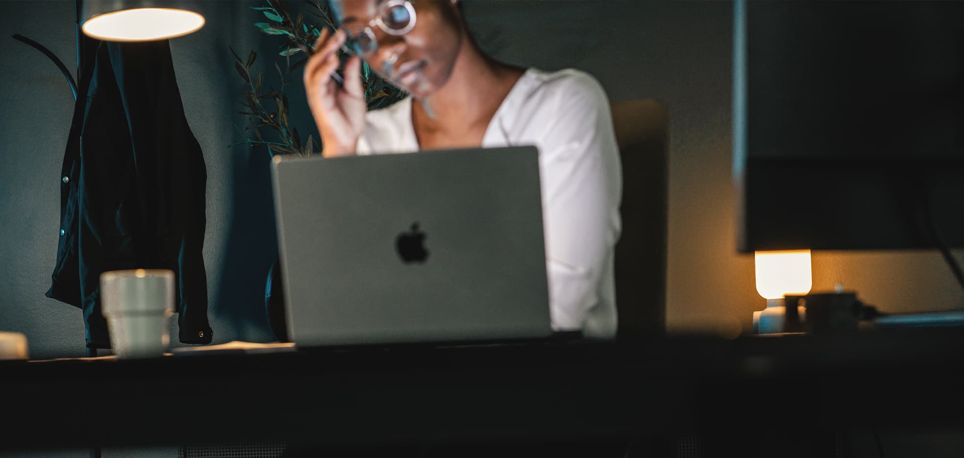 Kvinna sitter framför dator och tänker